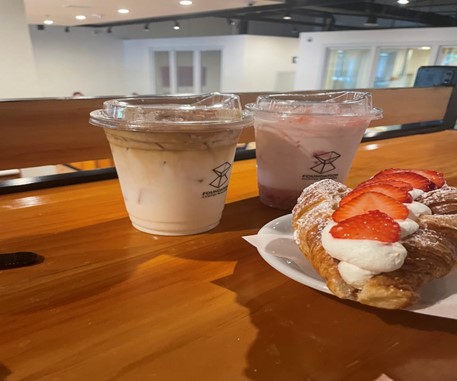 Some of the food at Foundations Coffee including a pastry, and strawberry and butterscotch lattes.